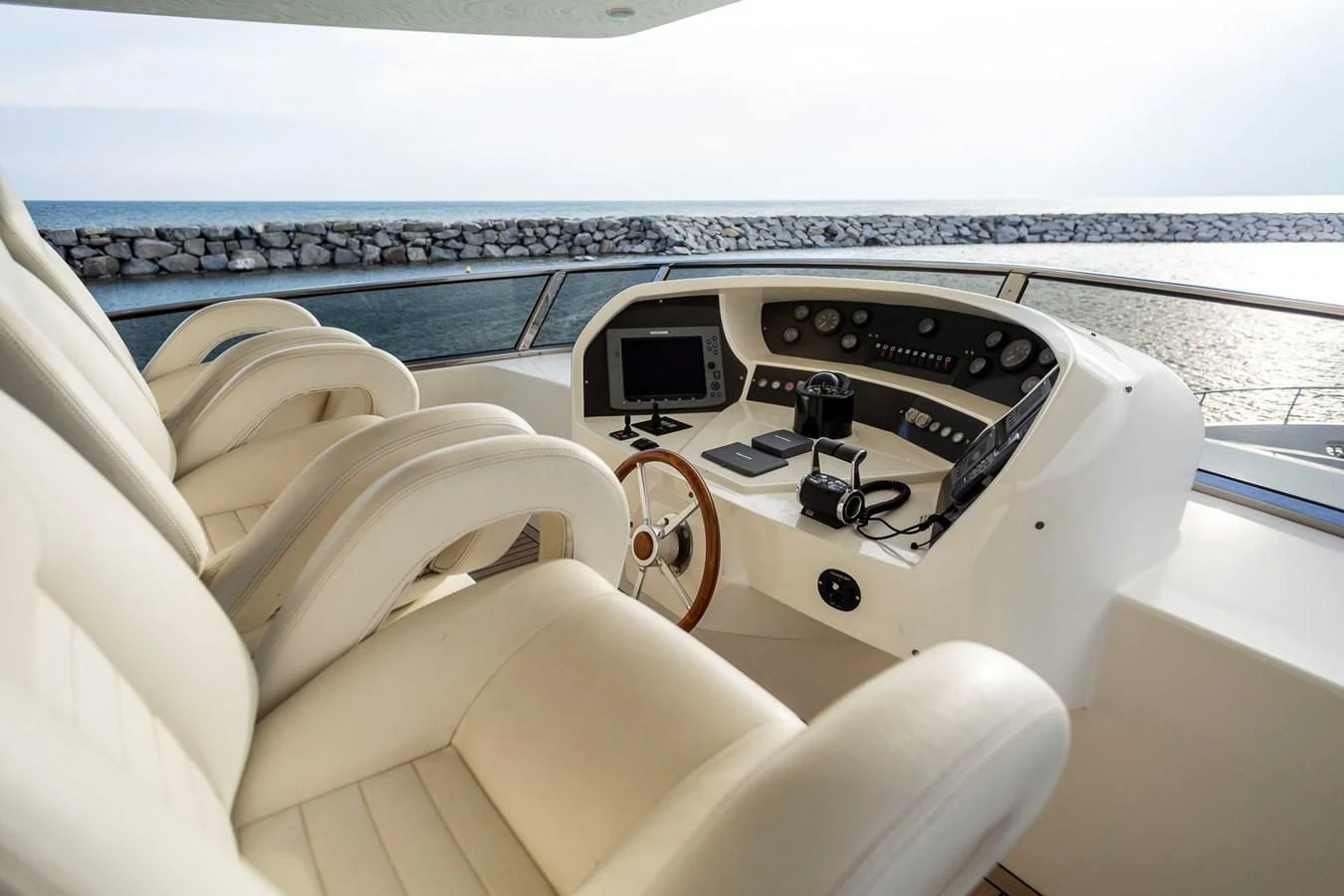 a hand holding a car steering wheel aboard GRACE Yacht for Sale
