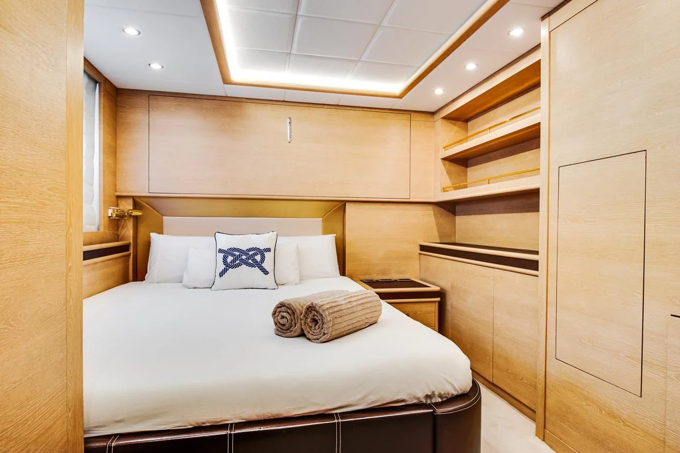 a bed with a white comforter aboard GRACE Yacht for Sale