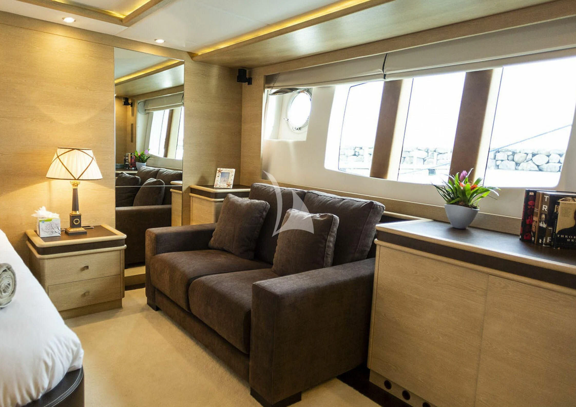 a living room with a couch and a window aboard GRACE Yacht for Sale