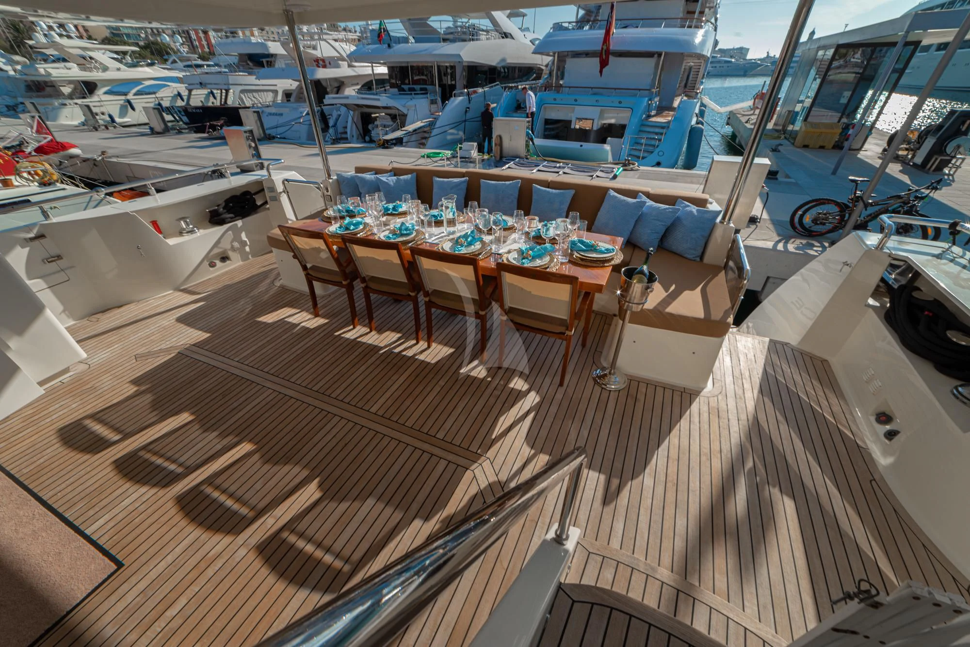 a boat deck with tables and chairs aboard GRACE Yacht for Sale