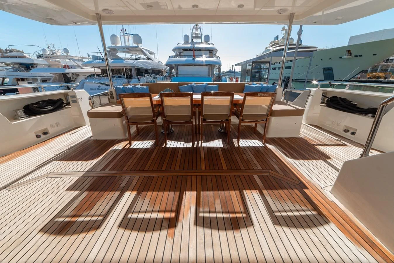 a deck with a table and chairs on it aboard GRACE Yacht for Sale