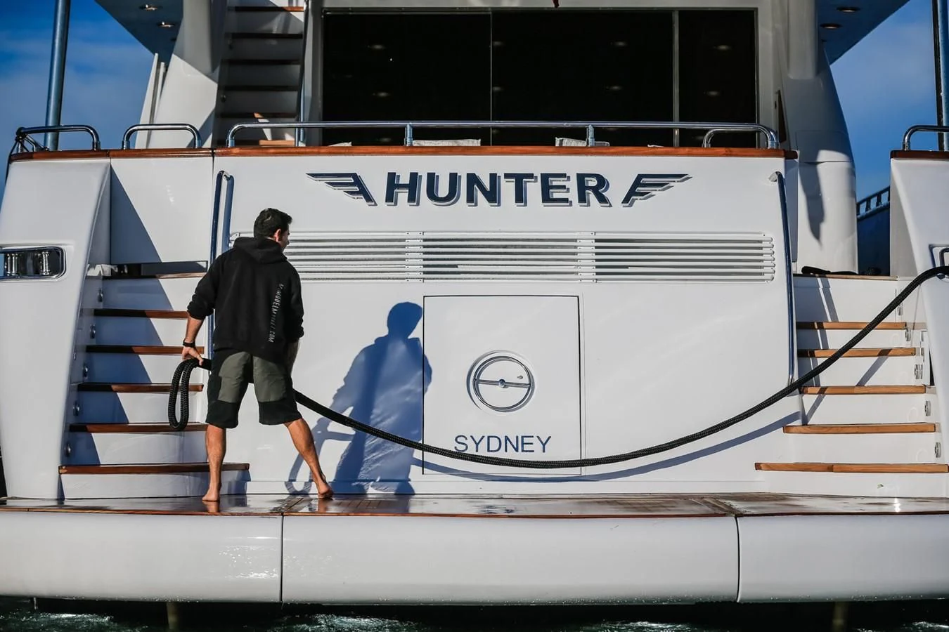 a man walking on a boat aboard HUNTER Yacht for Sale