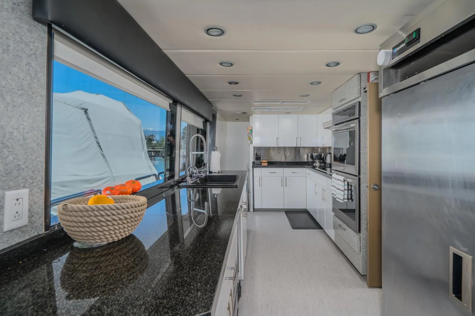 a large room with a large glass window and a large blue glass door aboard SOVEREIGN LADY Yacht for Sale