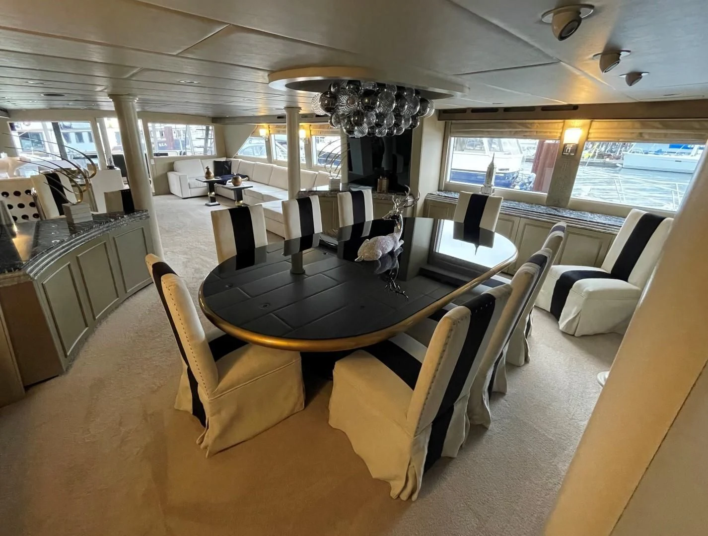 a room with a table chairs and a large window aboard SOVEREIGN LADY Yacht for Sale
