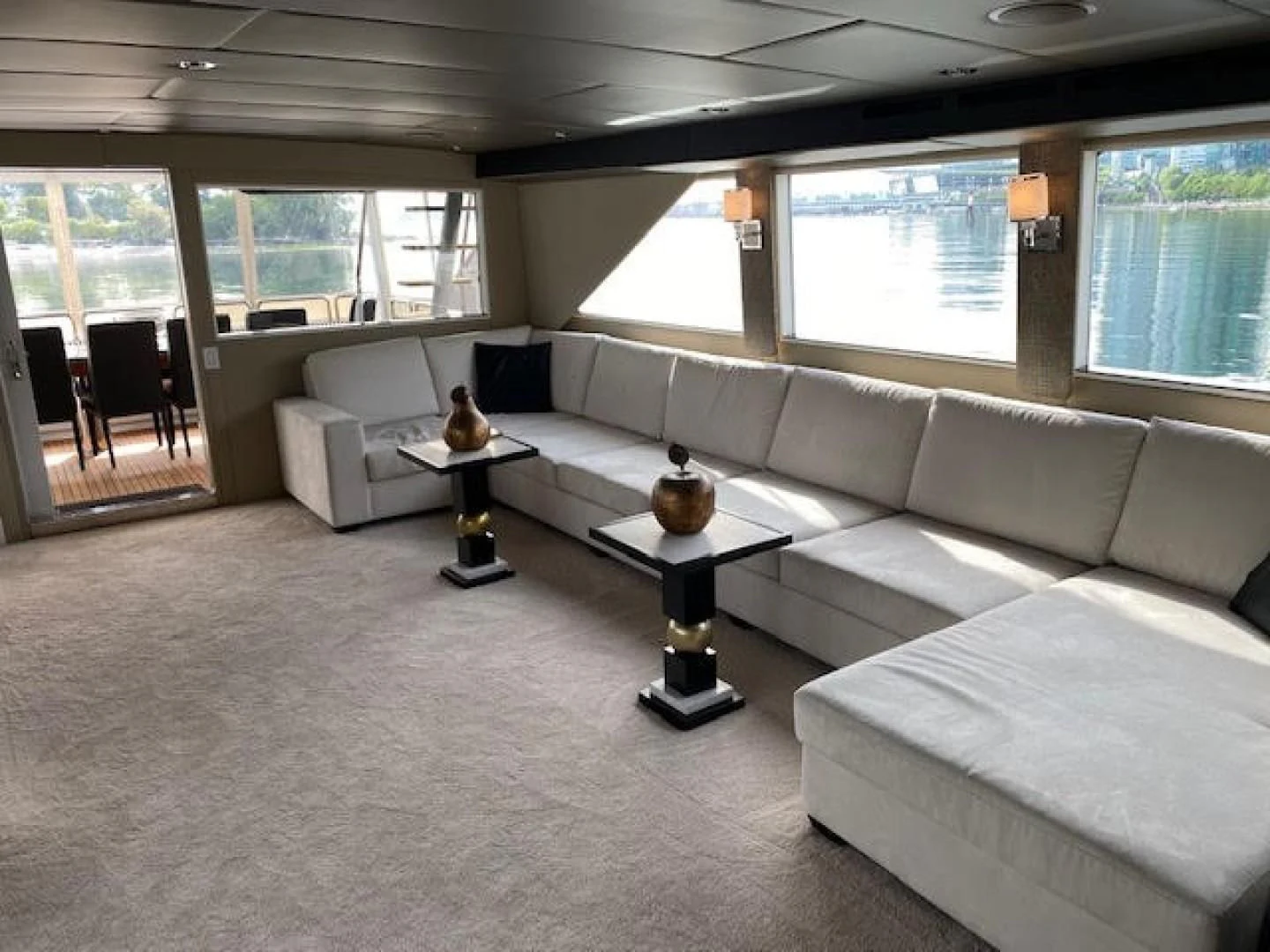 a living room with a couch and a coffee table aboard SOVEREIGN LADY Yacht for Sale
