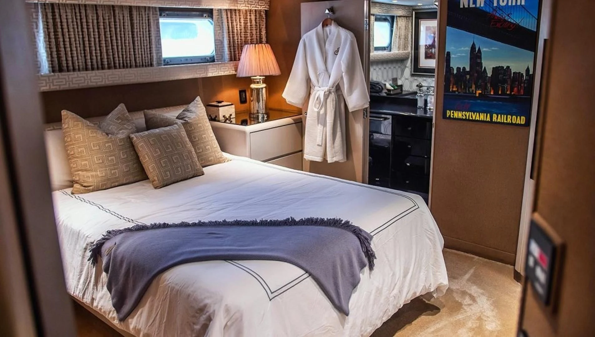 a bedroom with a bed and a lamp aboard SOVEREIGN LADY Yacht for Sale