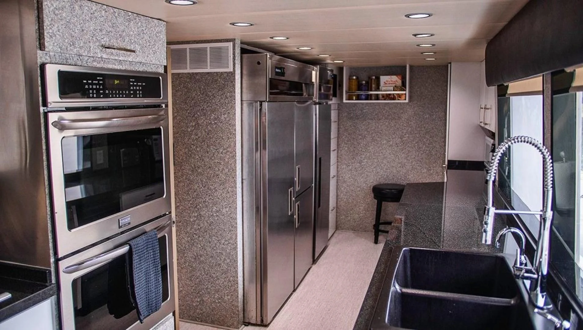 a kitchen with stainless steel appliances aboard SOVEREIGN LADY Yacht for Sale