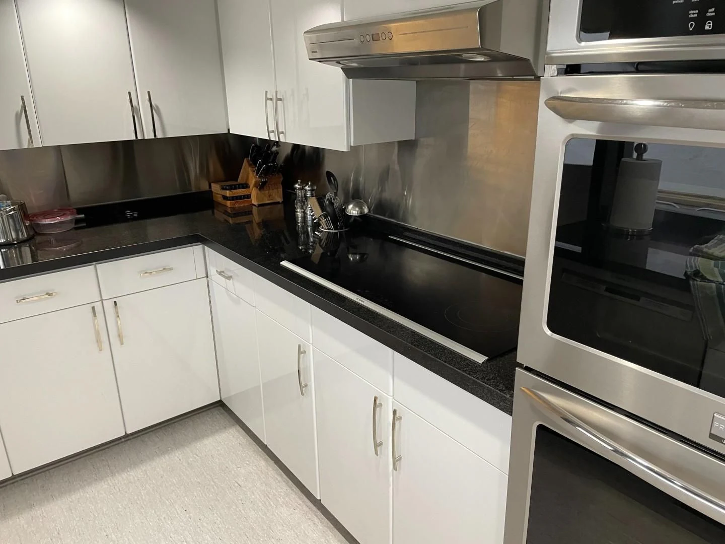 a kitchen with white cabinets aboard SOVEREIGN LADY Yacht for Sale