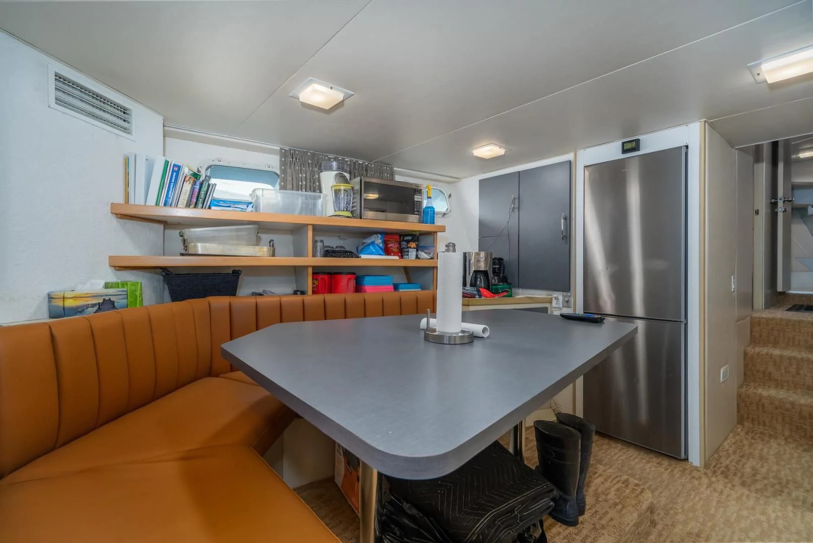 a living room with a table and a couch aboard SOVEREIGN LADY Yacht for Sale