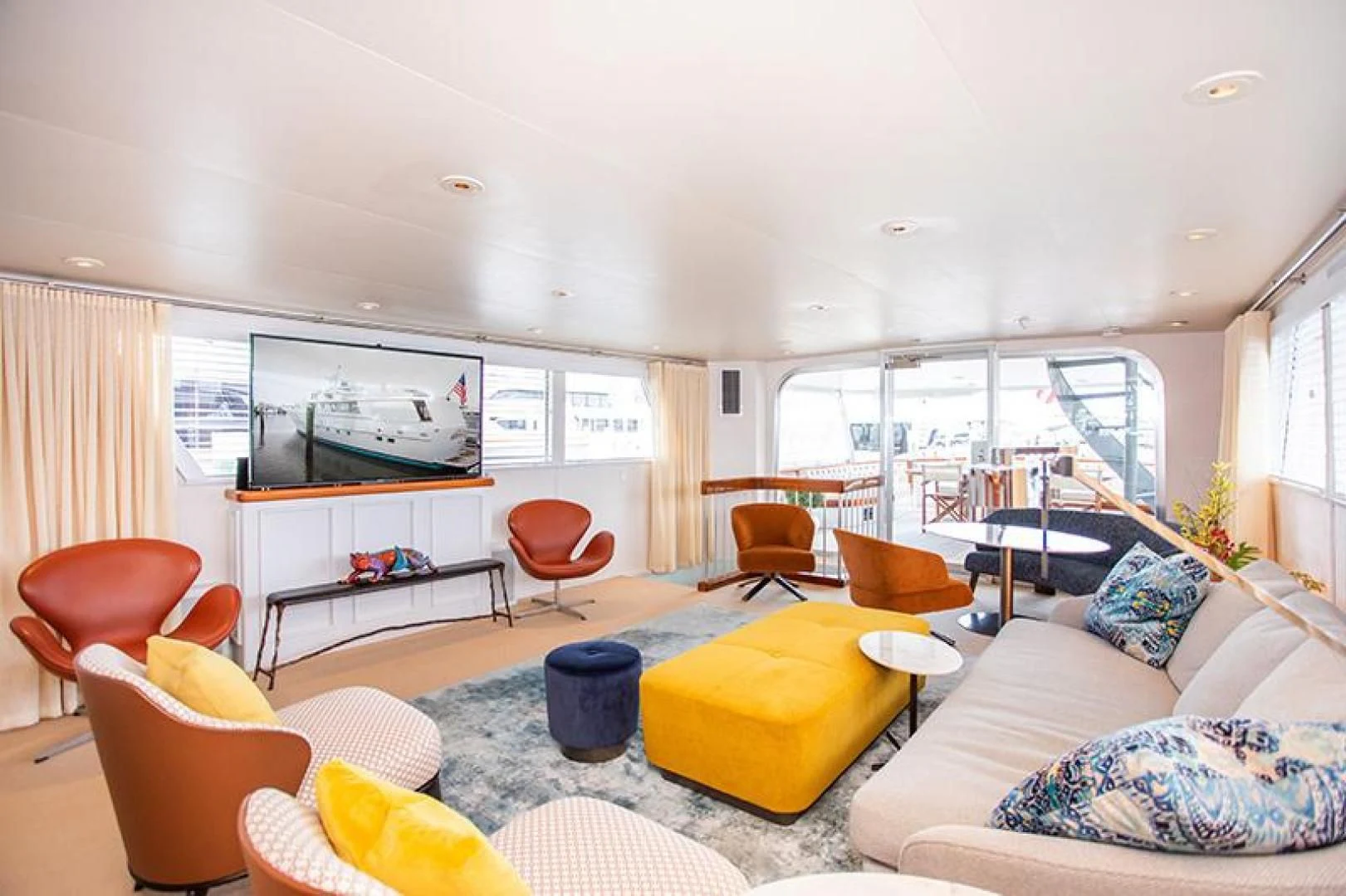 a living room with a large window aboard SOVEREIGN Yacht for Charter