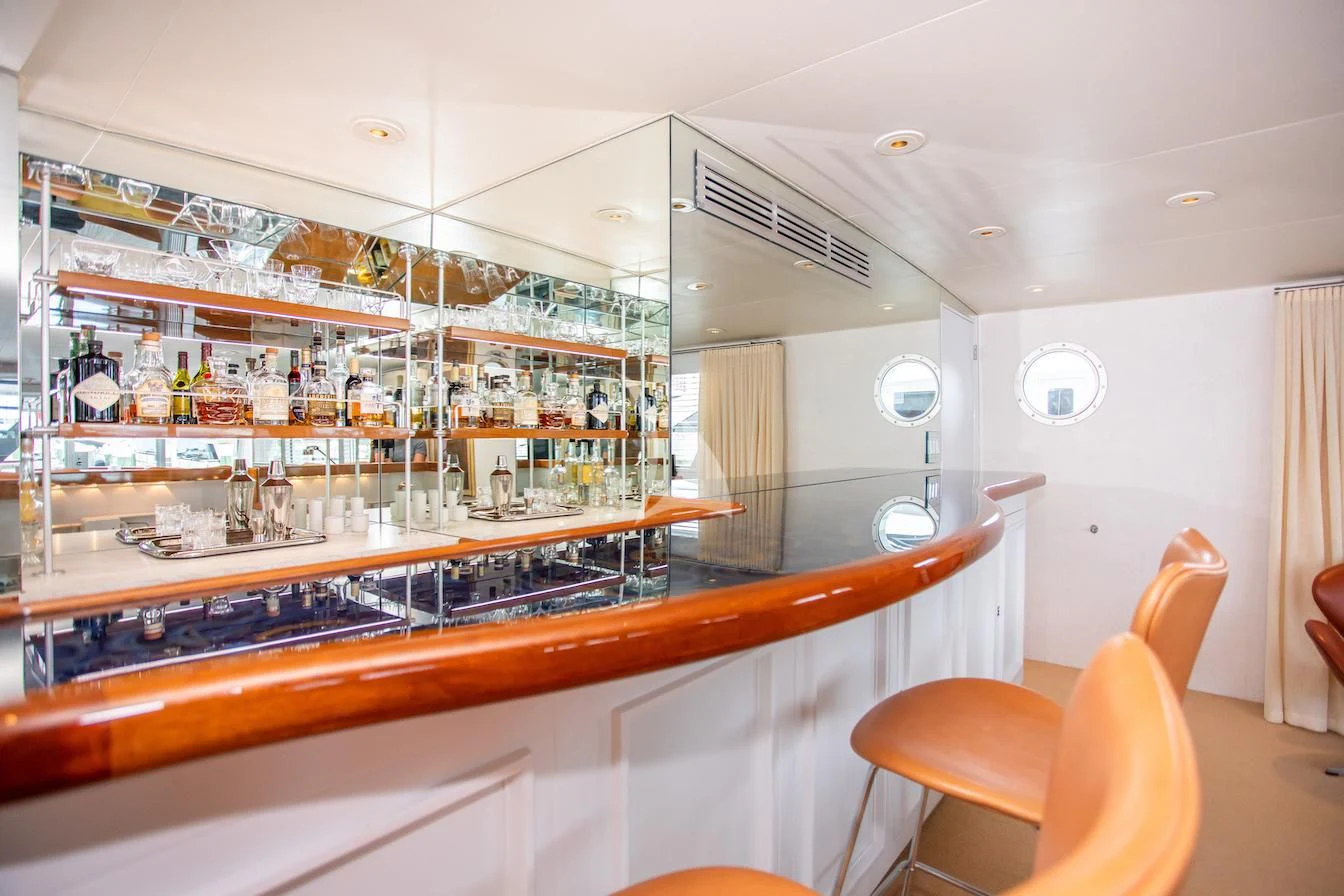 a kitchen with a bar and stools aboard SOVEREIGN Yacht for Charter