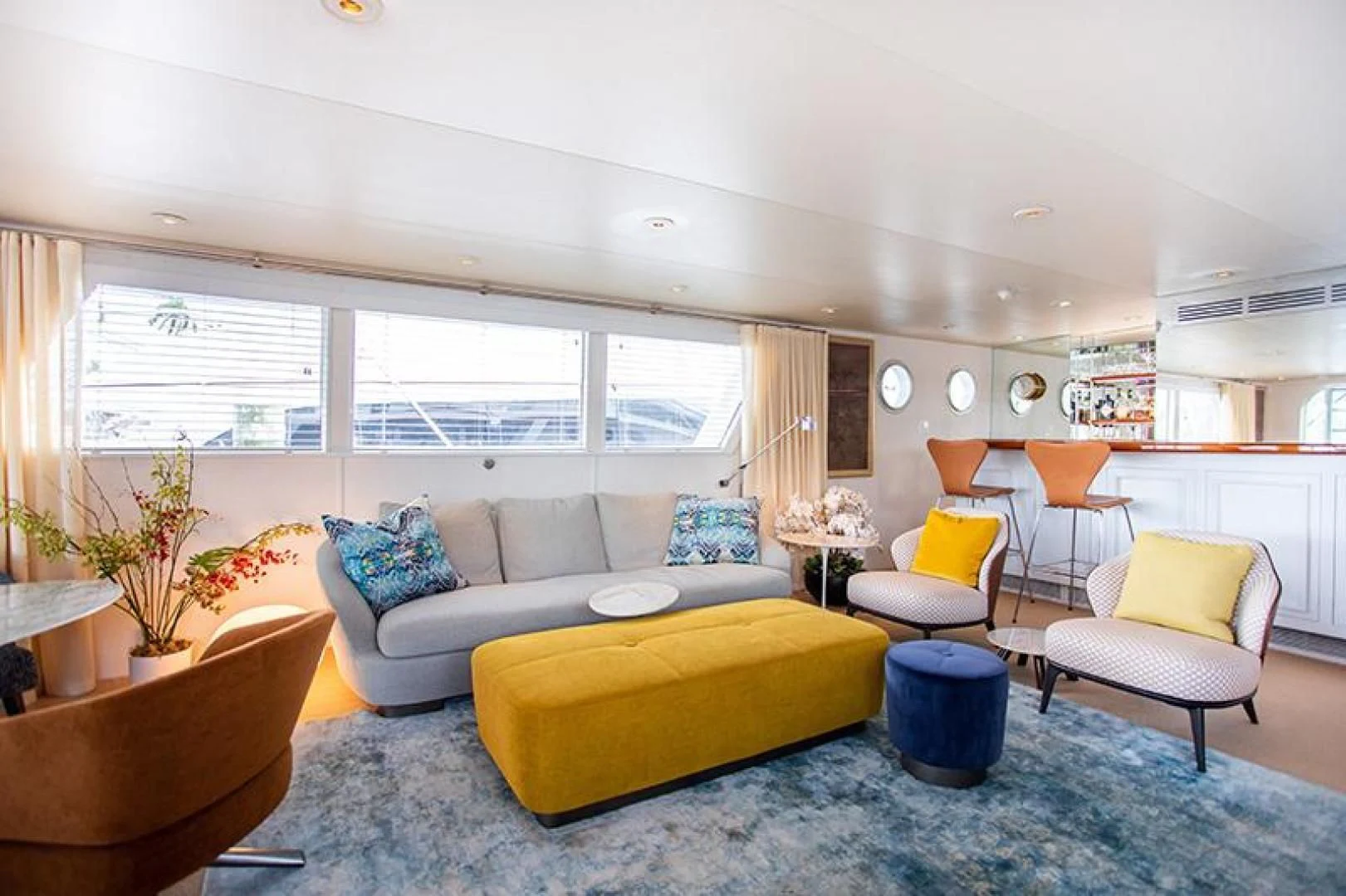 a living room with a couch and a yellow table aboard SOVEREIGN Yacht for Charter
