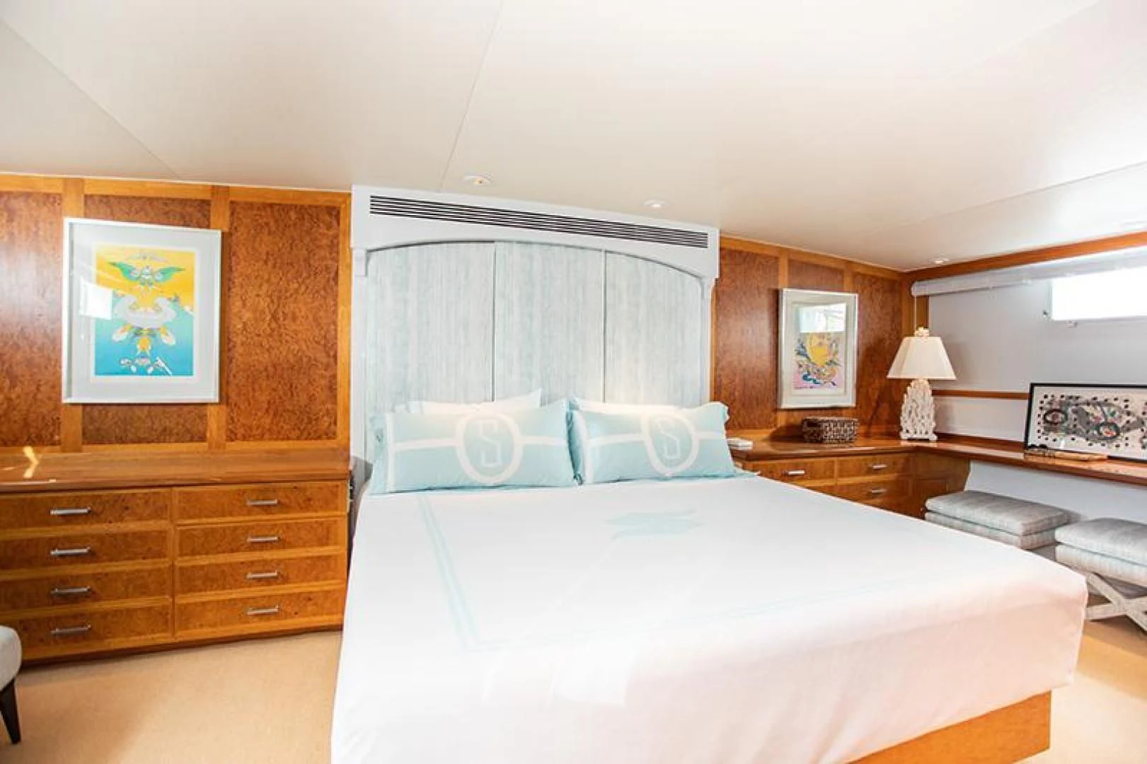 a bedroom with a bed and a desk aboard SOVEREIGN Yacht for Charter