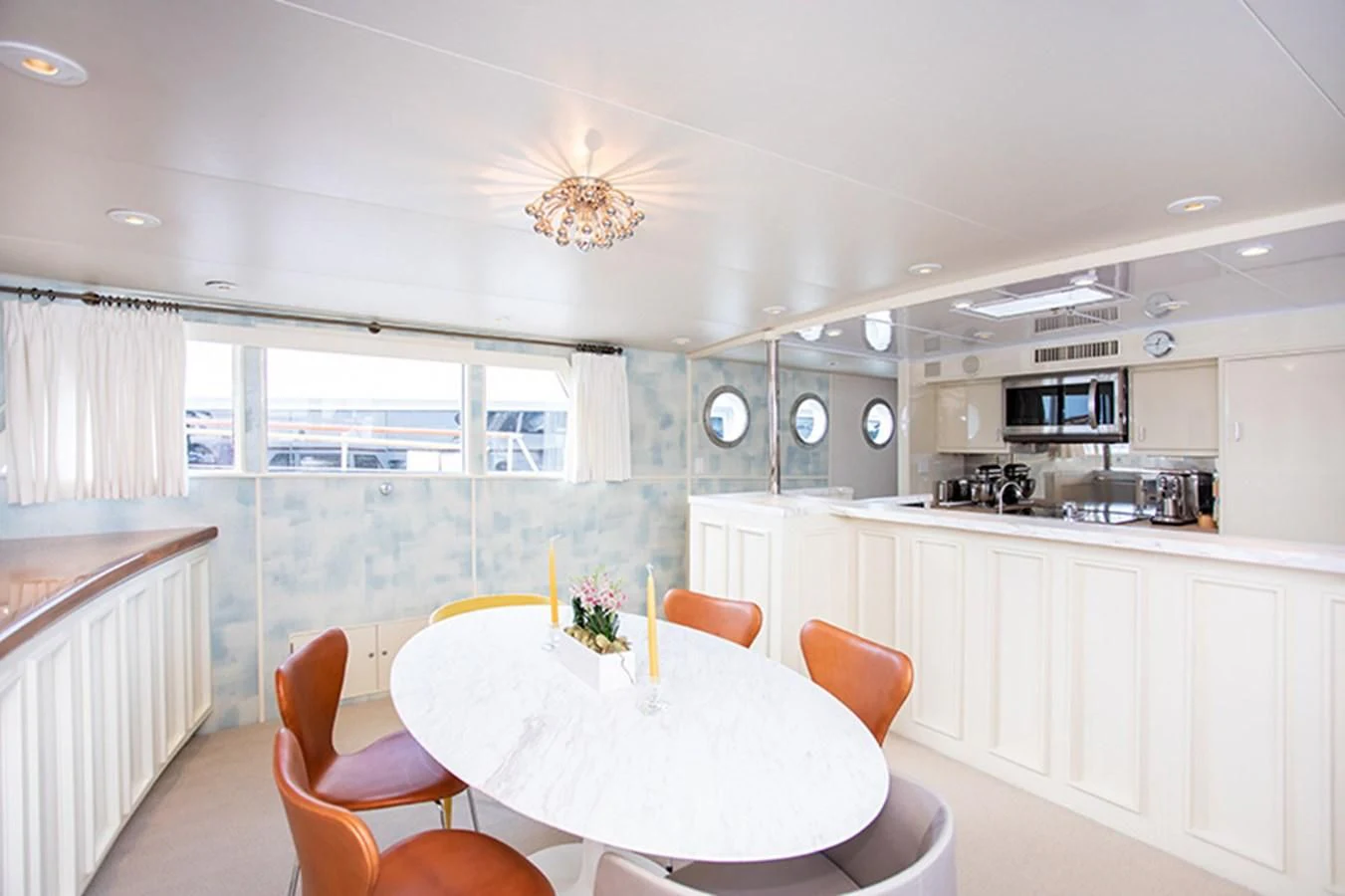 a kitchen with a table and chairs aboard SOVEREIGN Yacht for Charter