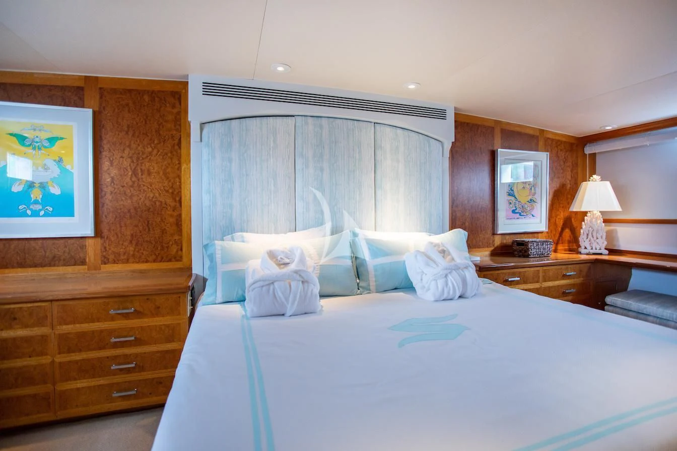 a bed with a white comforter aboard SOVEREIGN Yacht for Charter