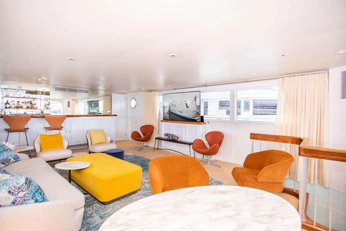 a living room with a table and chairs aboard SOVEREIGN Yacht for Charter
