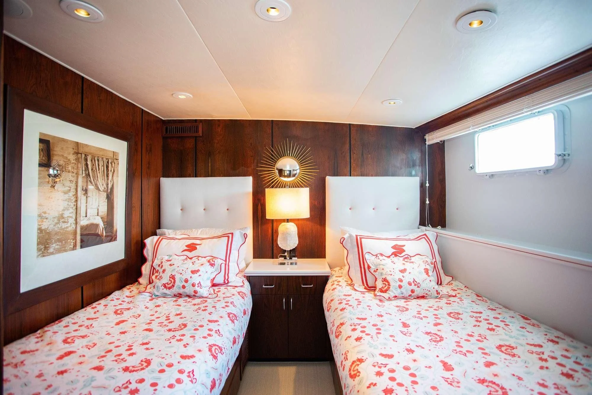 a couple of beds in a hotel room aboard SOVEREIGN Yacht for Charter