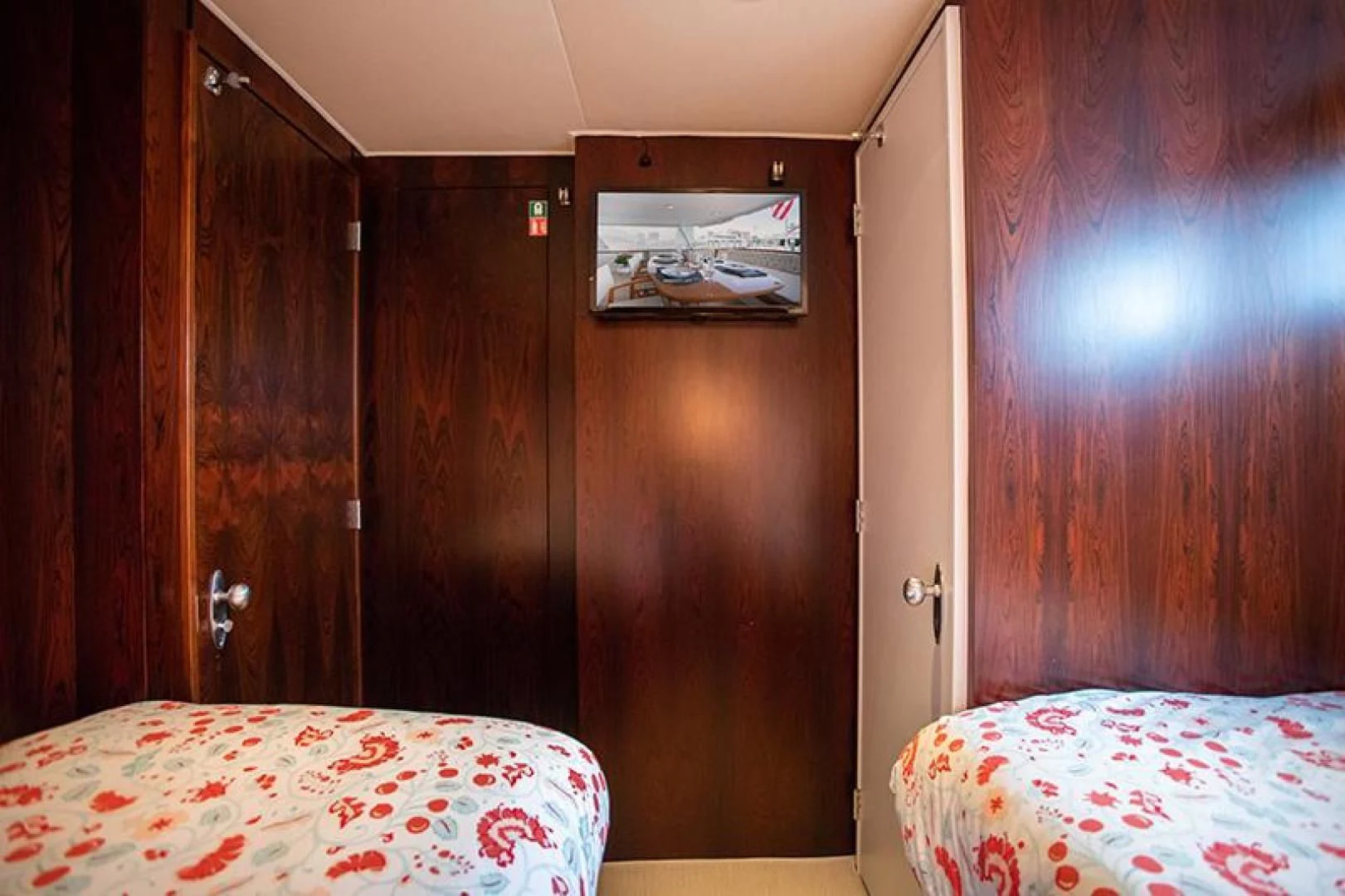 a room with a bed and a closet aboard SOVEREIGN Yacht for Charter