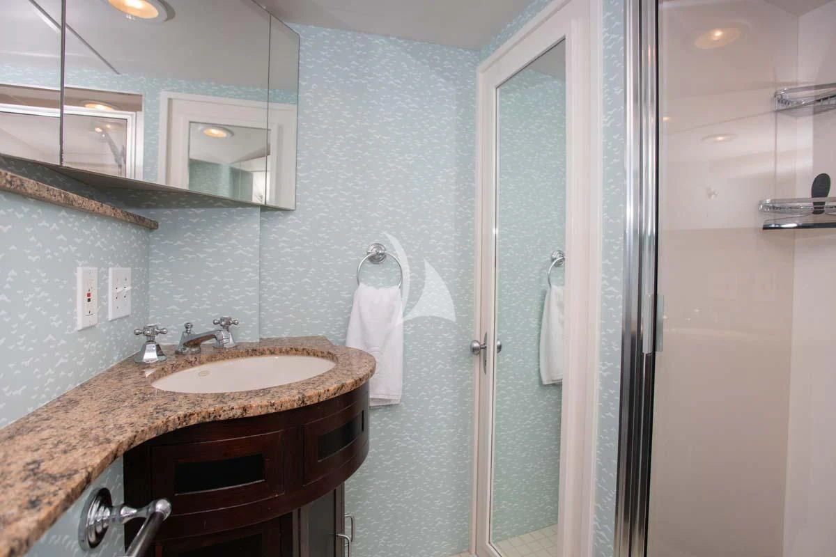 a bathroom with a sink and a mirror aboard SOVEREIGN Yacht for Charter