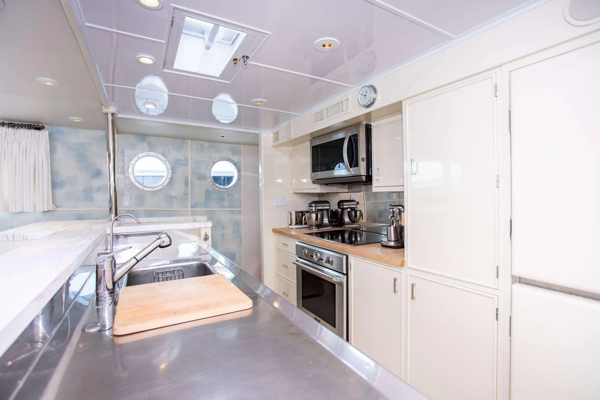 a kitchen with white cabinets aboard SOVEREIGN Yacht for Charter
