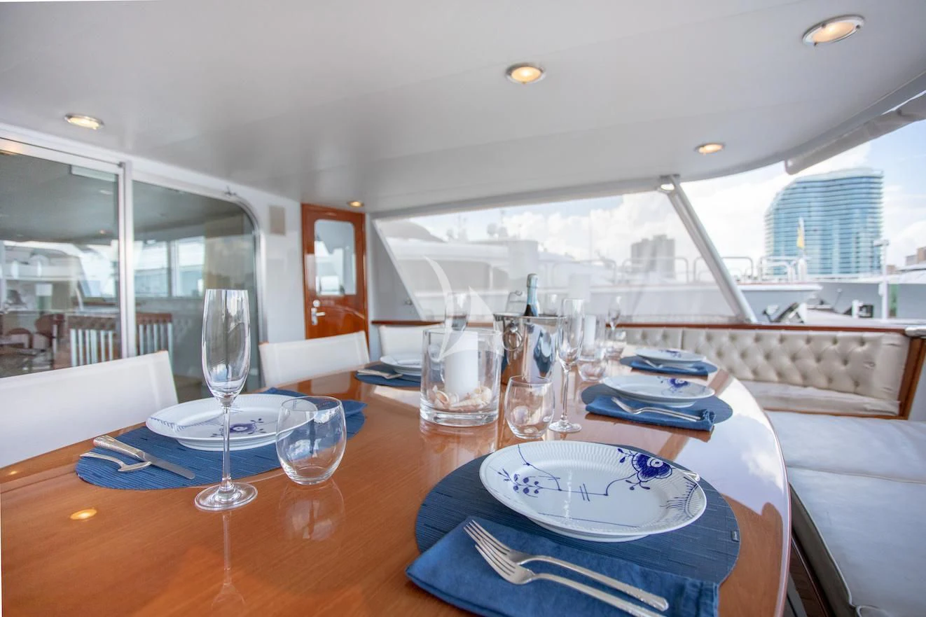 a dining room with a table and chairs aboard SOVEREIGN Yacht for Charter