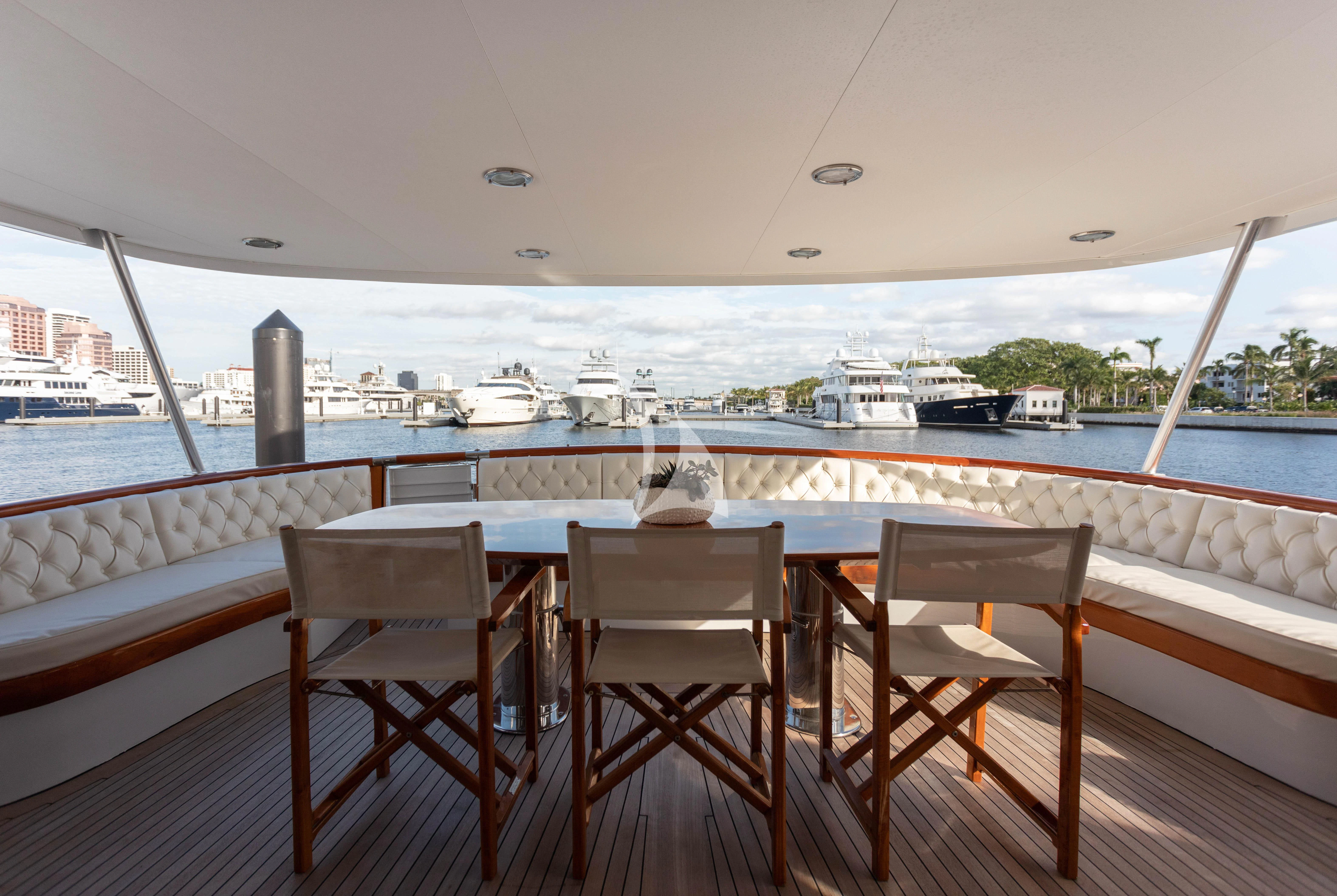 a couple of chairs on a deck overlooking a body of water aboard SOVEREIGN Yacht for Charter