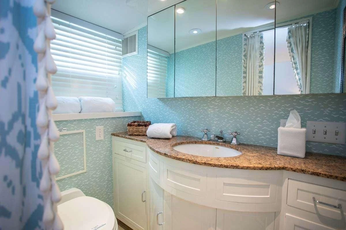 a bathroom with a sink and a mirror aboard SOVEREIGN Yacht for Charter