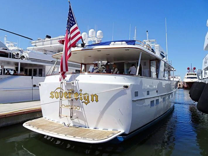 a boat with a flag on the front aboard SOVEREIGN Yacht for Charter