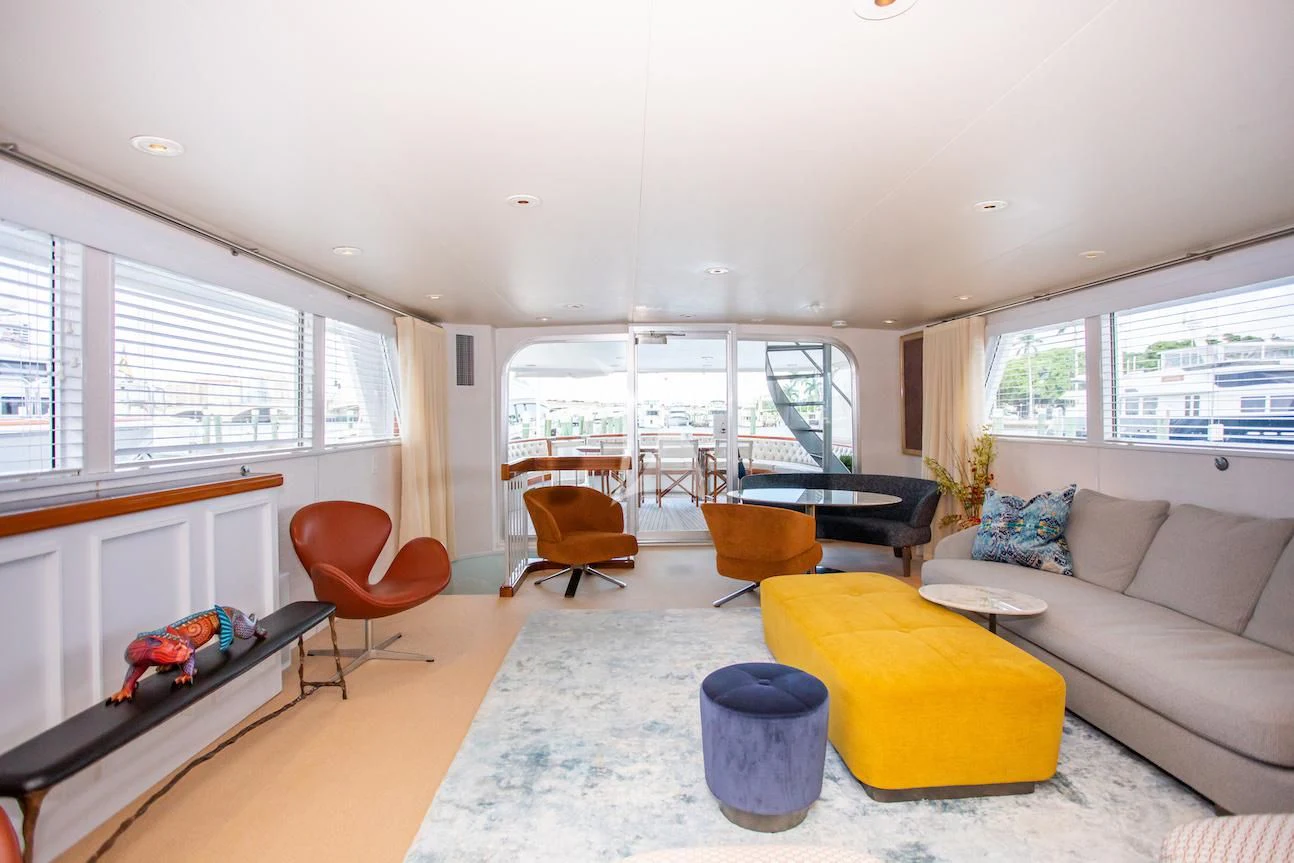 a living room with a couch and a table aboard SOVEREIGN Yacht for Charter