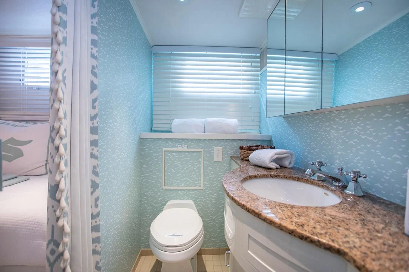 a bathroom with a sink and a toilet aboard SOVEREIGN Yacht for Charter