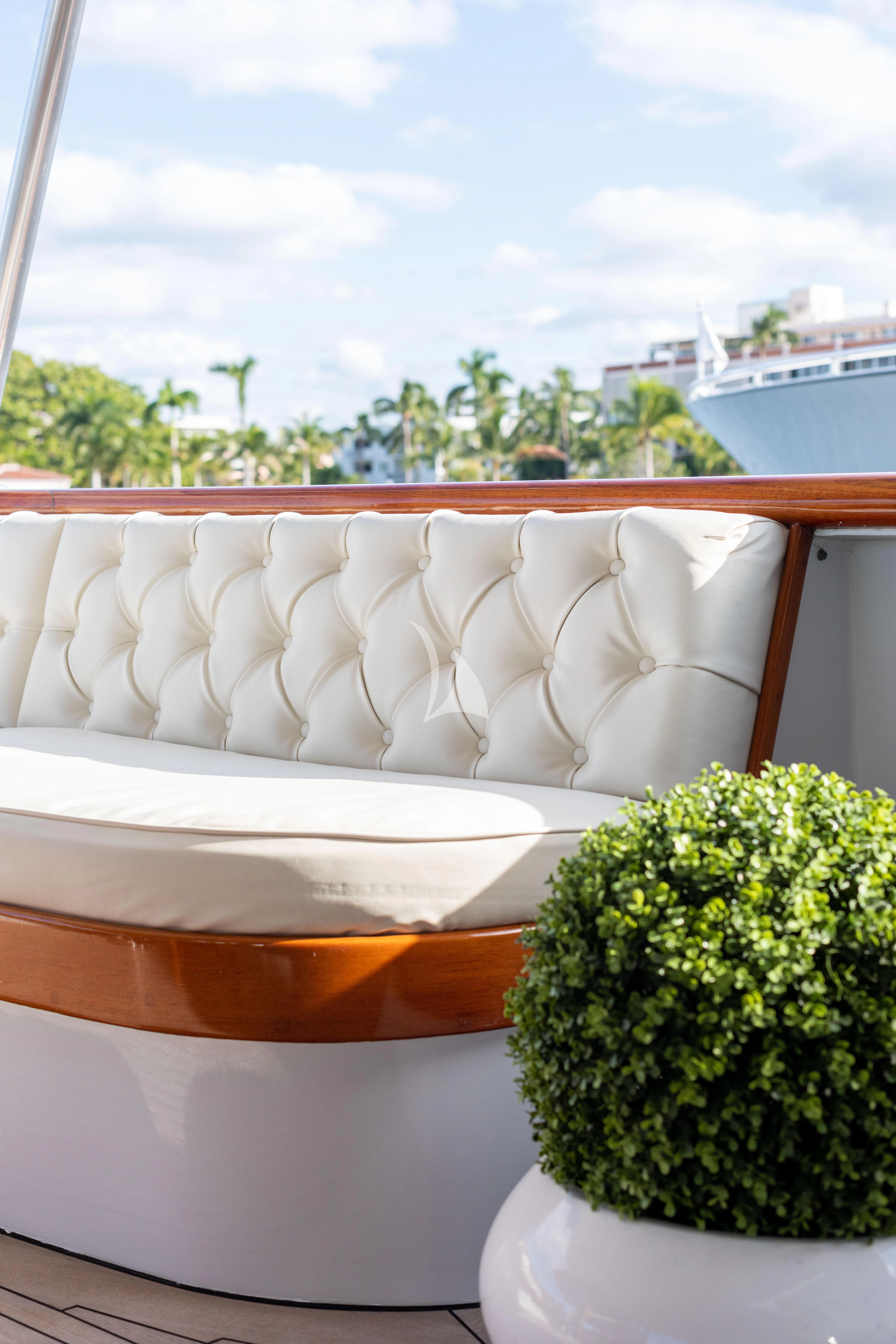 a white couch on a table aboard SOVEREIGN Yacht for Charter