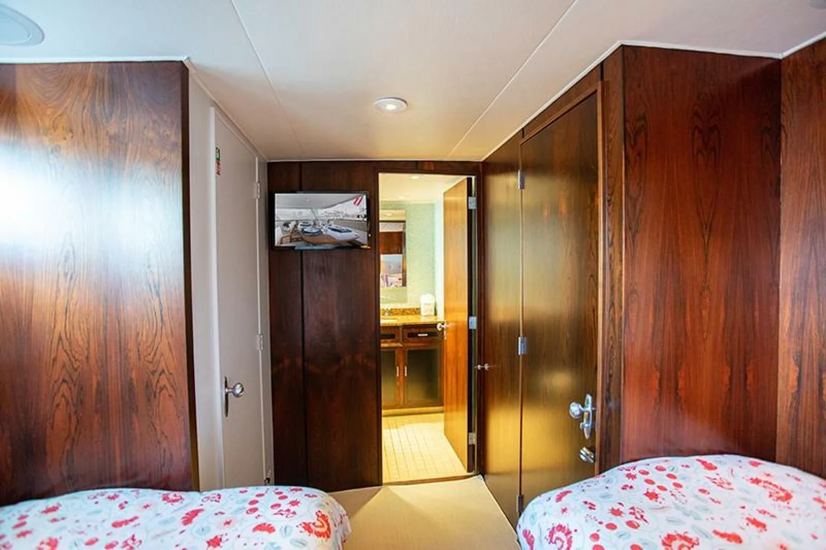 a room with a bed and a closet aboard SOVEREIGN Yacht for Charter