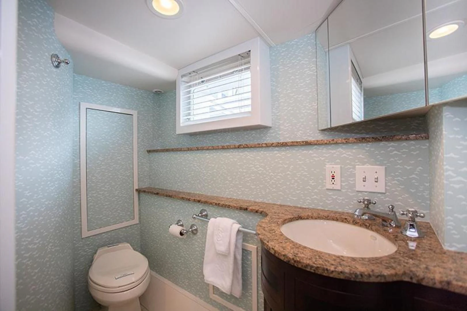 a bathroom with a sink and toilet aboard SOVEREIGN Yacht for Charter