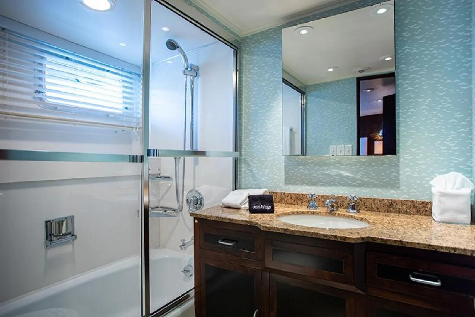 a bathroom with a sink and a bathtub aboard SOVEREIGN Yacht for Charter