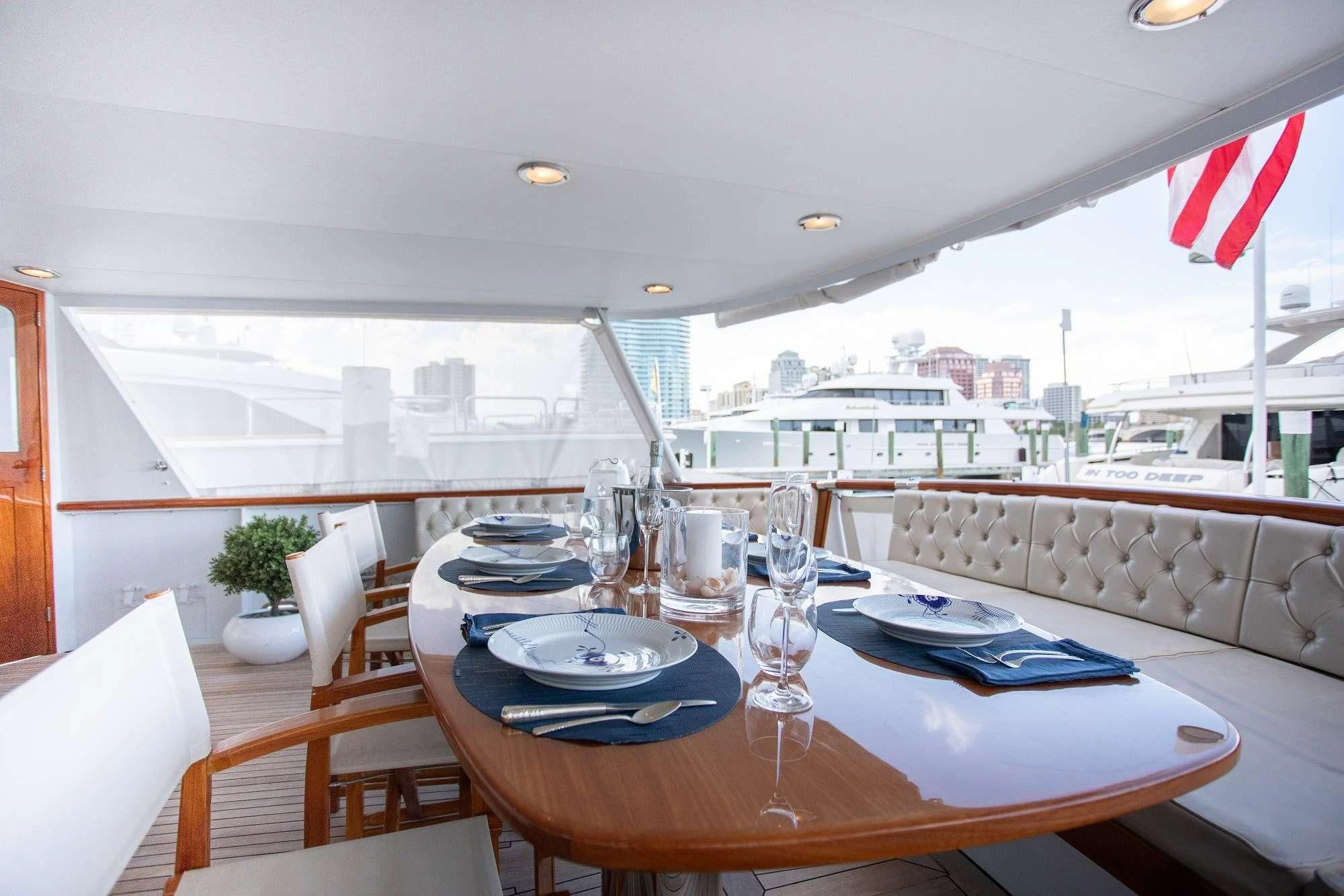 a table with plates and glasses on it aboard SOVEREIGN Yacht for Charter