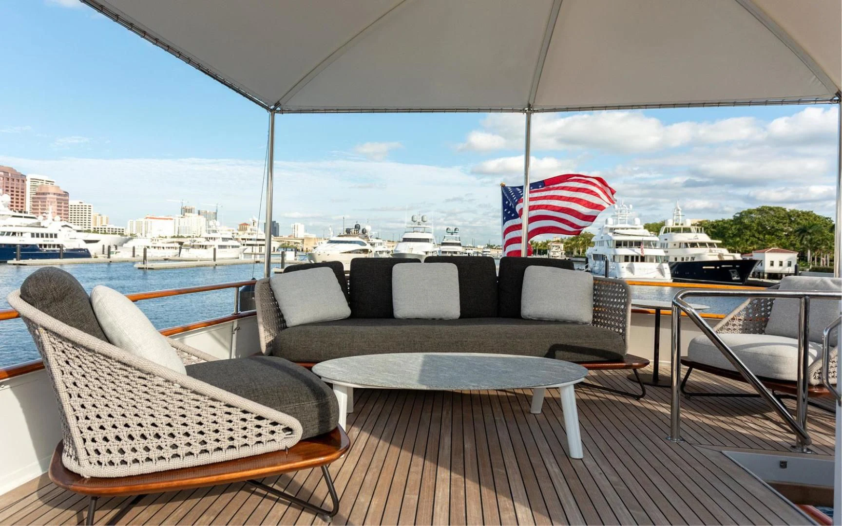 a table and chairs on a deck aboard SOVEREIGN Yacht for Charter