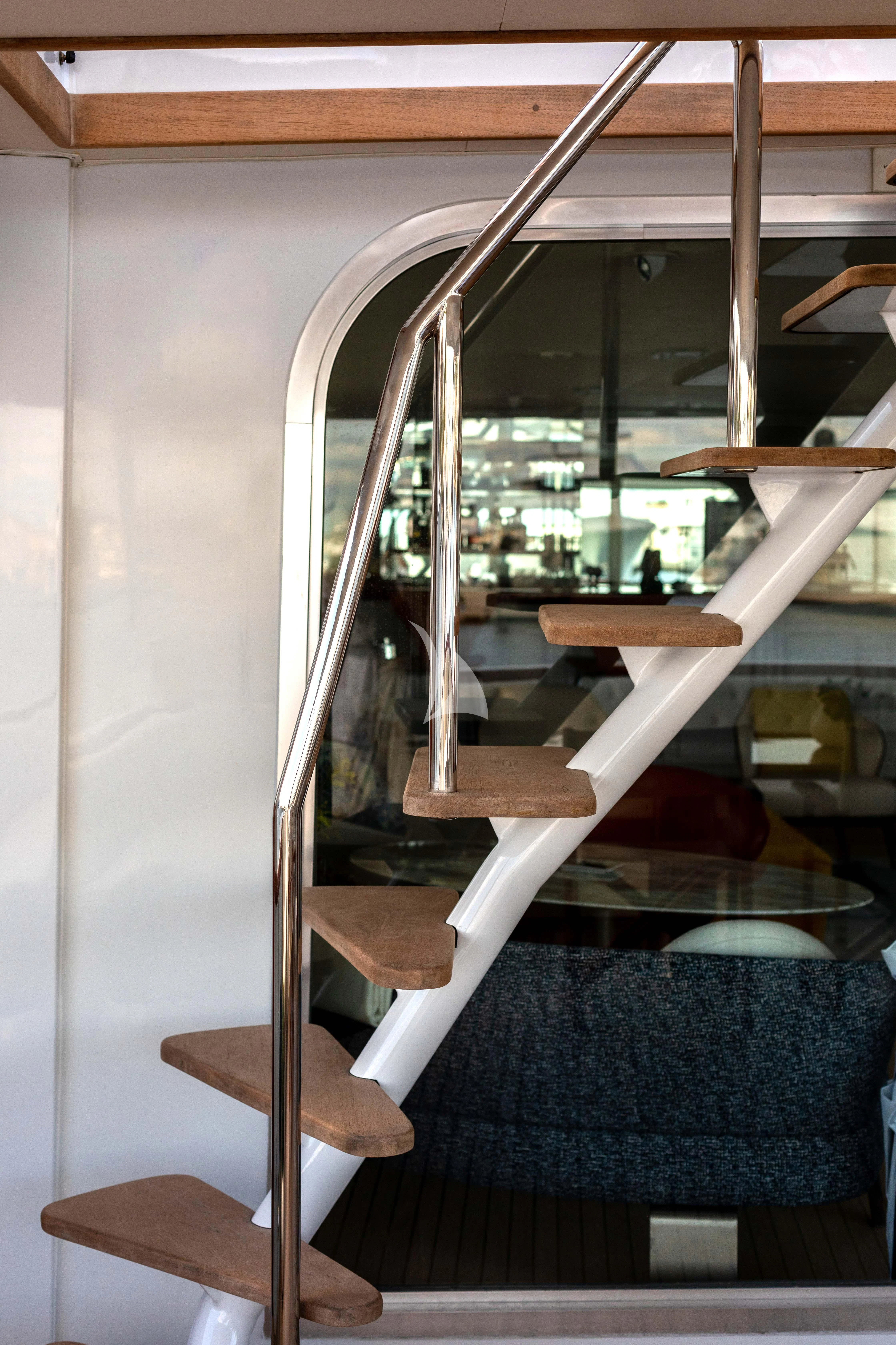 a wooden staircase with a railing aboard SOVEREIGN Yacht for Charter