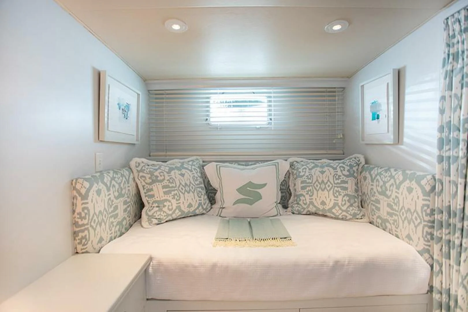 a couch with pillows on it aboard SOVEREIGN Yacht for Charter