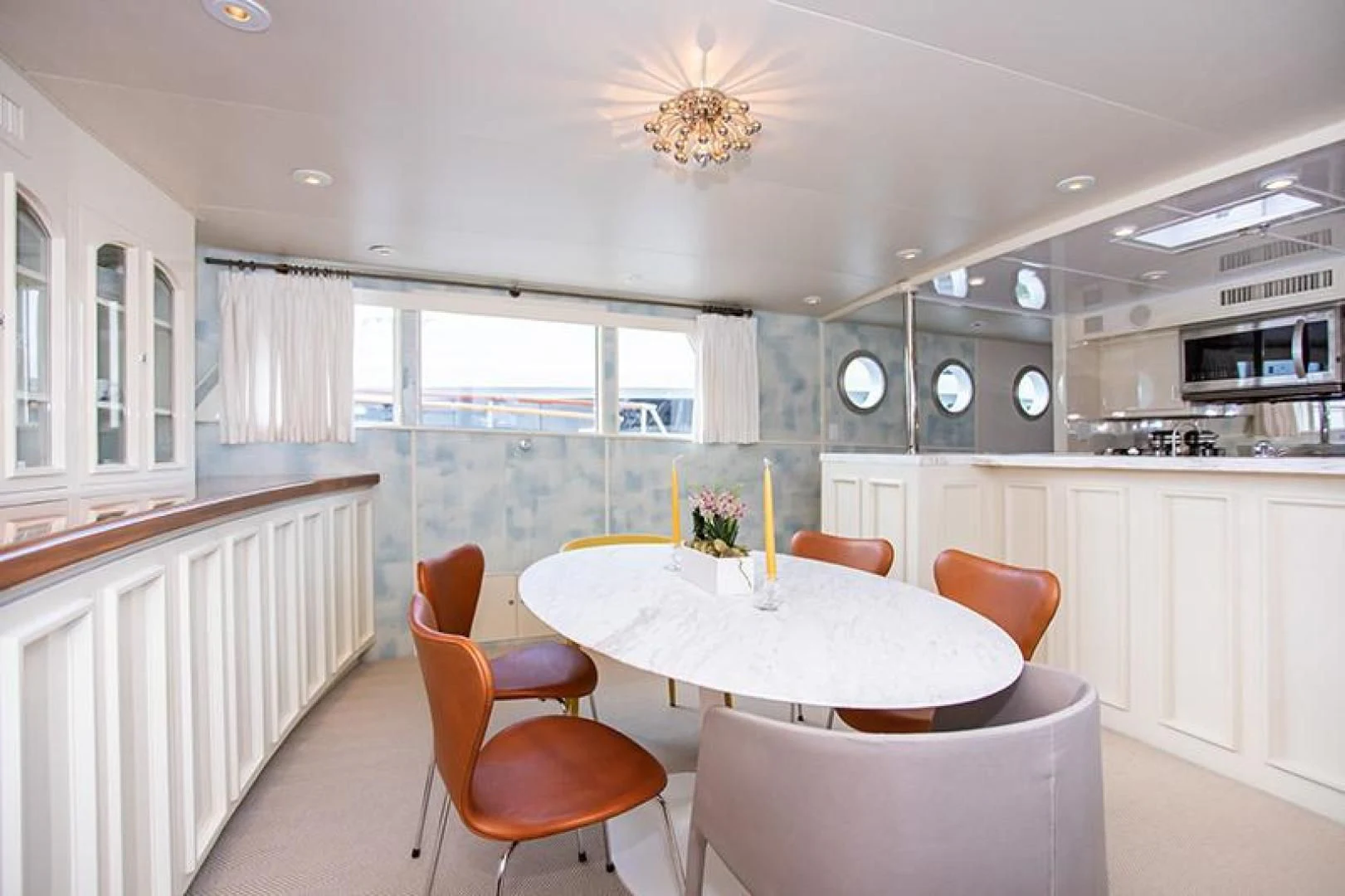 a kitchen with a table and chairs aboard SOVEREIGN Yacht for Charter