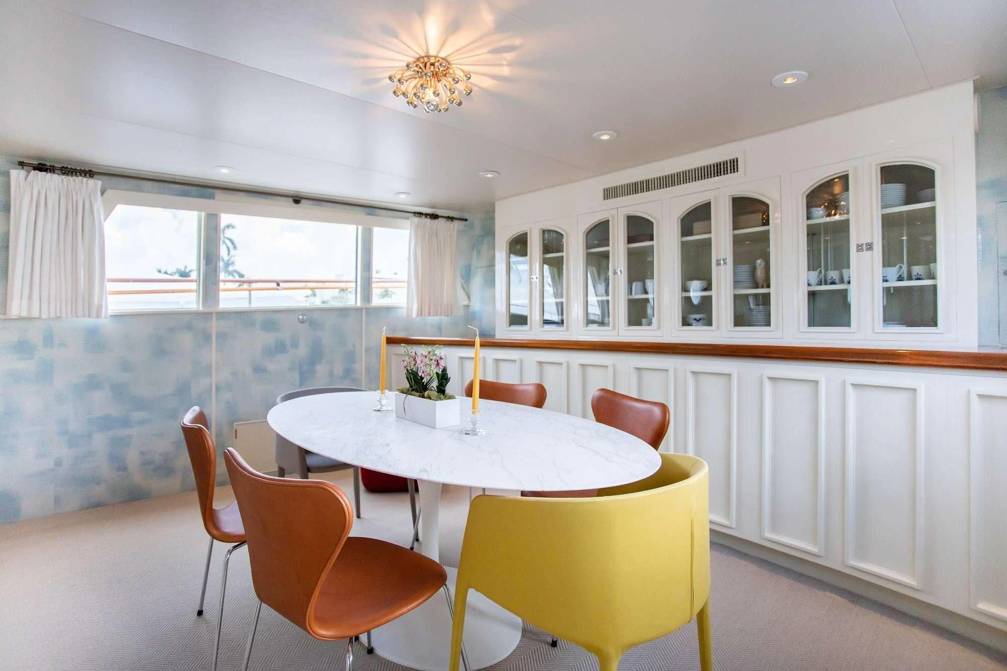 a dining room with a table and chairs aboard SOVEREIGN Yacht for Charter