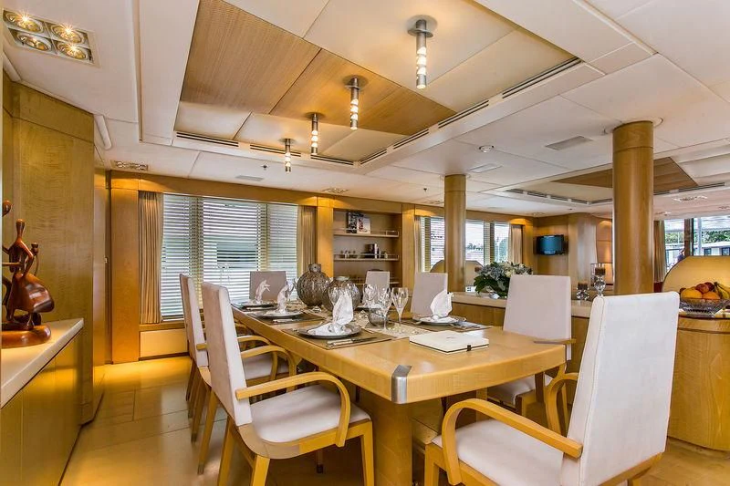 a dining room with a table and chairs aboard BACA Yacht for Charter