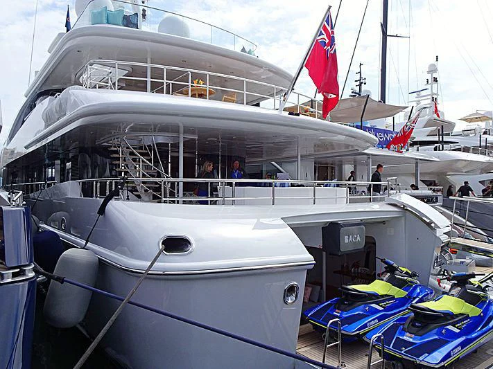 a boat with a flag on the front aboard BACA Yacht for Charter