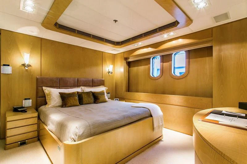 a room with a bed and a table aboard BACA Yacht for Charter