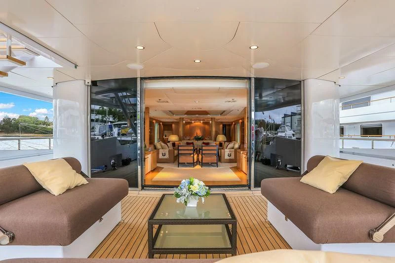 a living room with a glass wall aboard BACA Yacht for Charter
