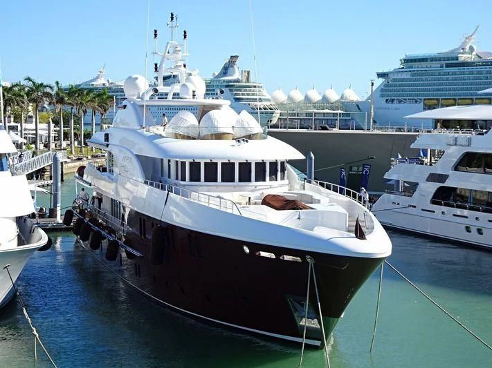 a large boat docked at a pier aboard BACA Yacht for Charter