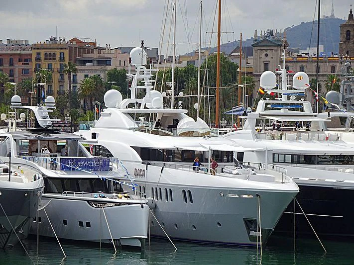 several boats docked in a harbor aboard BACA Yacht for Charter