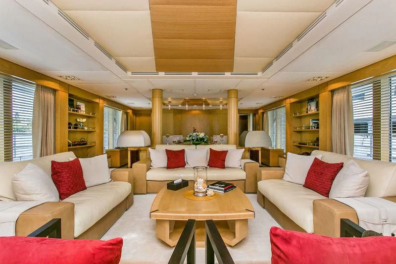 a living room with a table and couches aboard BACA Yacht for Charter