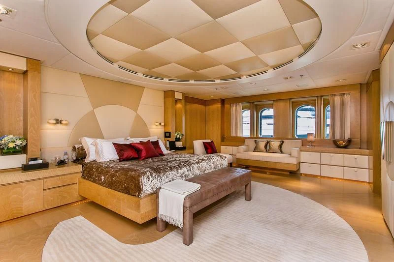 a large living room with a large bed and a large window aboard BACA Yacht for Charter