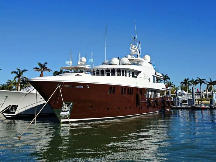 a large boat docked at a pier aboard BACA Yacht for Charter