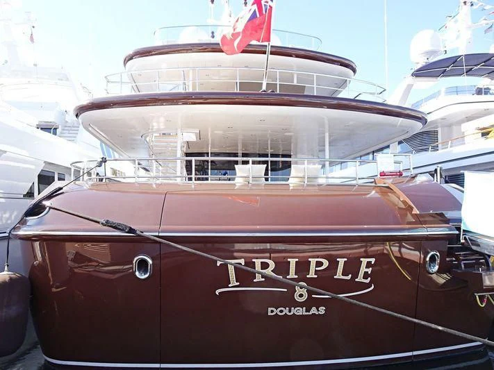 a boat with a flag on the front aboard BACA Yacht for Charter
